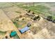 Aerial perspective of the property featuring barns and housing at 4295 S County Road 193, Byers, CO 80103
