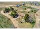 Expansive ranch property featuring a charming single-story home, outbuildings, and mature trees at 4295 S County Road 193, Byers, CO 80103