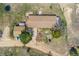 Well-maintained home with an expansive yard, stone patio, and outbuildings, surrounded by mature trees at 4295 S County Road 193, Byers, CO 80103