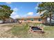 Exterior view of ranch-style house with brick-lined water feature and adjacent storage shed at 4295 S County Road 193, Byers, CO 80103
