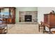 Living room stone fireplace with mantle and carpeted floors at 4295 S County Road 193, Byers, CO 80103