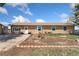 Ranch style home featuring a landscaped yard and covered entry at 4295 S County Road 193, Byers, CO 80103