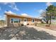 Single story home featuring covered porch and mature tree at 4295 S County Road 193, Byers, CO 80103