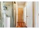 Hallway with laundry room, wooden floors and neutral walls at 4295 S County Road 193, Byers, CO 80103
