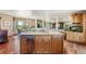 Kitchen with wood cabinets, stainless steel dishwasher, granite countertops, and wood floors at 4295 S County Road 193, Byers, CO 80103
