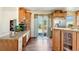 Well-lit kitchen featuring wood floors, granite counters, and a stainless steel refrigerator at 4295 S County Road 193, Byers, CO 80103