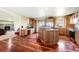 Spacious kitchen featuring wood floors, island with glass door cabinets, and stainless steel refrigerator at 4295 S County Road 193, Byers, CO 80103
