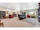 Inviting living room featuring plush carpeting, an open layout, and seamless flow into the dining and kitchen at 4295 S County Road 193, Byers, CO 80103