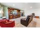 Comfortable living room with plush seating, a stone fireplace, and a large entertainment center with a TV at 4295 S County Road 193, Byers, CO 80103
