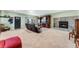 Carpeted living room with stone fireplace, large windows, and cozy seating at 4295 S County Road 193, Byers, CO 80103