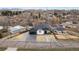 An aerial view of a modern two-story home with a black roof, set among mature trees and manicured landscaping at 12215 Viewpoint Dr, Lakewood, CO 80401