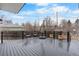 Back deck with outdoor seating and views of treed yard at 12215 Viewpoint Dr, Lakewood, CO 80401