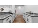 Finished basement with a wet bar, modern white cabinets, and luxury countertops at 12215 Viewpoint Dr, Lakewood, CO 80401