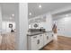 Finished basement bar area with stylish white cabinetry and granite countertops at 12215 Viewpoint Dr, Lakewood, CO 80401