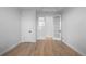 Spacious room with stylish, light wood flooring, a sliding door, and white doors, offering versatility at 12215 Viewpoint Dr, Lakewood, CO 80401