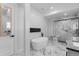 Bright bathroom with free standing tub, glass shower, and dark hex tile feature at 12215 Viewpoint Dr, Lakewood, CO 80401