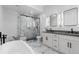 Modern bathroom with dual granite vanity, glass shower, and free standing tub at 12215 Viewpoint Dr, Lakewood, CO 80401