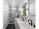 Elegant bathroom featuring dual sinks, marble tiling, and a glass-enclosed shower, creating a spa-like feel at 12215 Viewpoint Dr, Lakewood, CO 80401