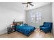 Comfortable bedroom with a ceiling fan, natural light and blue accents, ready for relaxation at 12215 Viewpoint Dr, Lakewood, CO 80401