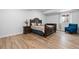 Bedroom features detailed wood bed frame, wood-look floors and bright natural light at 12215 Viewpoint Dr, Lakewood, CO 80401