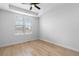 Bright bedroom with large windows, a ceiling fan, and light wood flooring, exuding a serene atmosphere at 12215 Viewpoint Dr, Lakewood, CO 80401