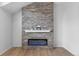 Modern electric fireplace with a stone accent wall and decorative mantle at 12215 Viewpoint Dr, Lakewood, CO 80401