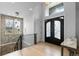 Inviting foyer with high ceilings, decorative lighting, and a staircase with black metal railings at 12215 Viewpoint Dr, Lakewood, CO 80401