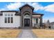 Elegant front entrance with an arched stone feature, decorative door, and welcoming walkway at 12215 Viewpoint Dr, Lakewood, CO 80401
