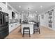 Modern kitchen boasts white cabinets, stainless appliances, granite counters, island seating, and wood flooring at 12215 Viewpoint Dr, Lakewood, CO 80401