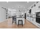 Modern kitchen boasts stainless steel appliances, large island, and open concept layout for dining and entertaining at 12215 Viewpoint Dr, Lakewood, CO 80401