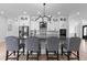 This kitchen features an island with barstool seating, granite countertops, and modern light fixture at 12215 Viewpoint Dr, Lakewood, CO 80401