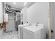 Functional laundry room with modern appliances and marble-look floors at 12215 Viewpoint Dr, Lakewood, CO 80401