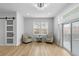 Cozy sitting area with a sliding glass door, wood floors, two chairs, and a table between the chairs at 12215 Viewpoint Dr, Lakewood, CO 80401