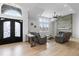 Open-concept living room with high ceilings, large windows, and a stunning stone fireplace at 12215 Viewpoint Dr, Lakewood, CO 80401