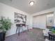 Cozy living room features a wooden desk, potted plant and neutral color carpet at 46505 Avery Ln, Commerce City, CO 80022