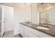 Bathroom featuring double sinks, a sleek countertop, modern fixtures, and a glass-enclosed shower at 6562 Arbor Blvd # 1, Thornton, CO 80602