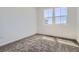 Cozy bedroom with plush carpet, neutral walls, and large windows providing natural light and neighborhood views at 6562 Arbor Blvd # 1, Thornton, CO 80602