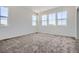 Light-filled bedroom with plush carpet, large windows with neighborhood views, and ample space for furniture at 6562 Arbor Blvd # 1, Thornton, CO 80602