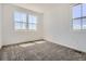 Bright bedroom with neutral walls, plush carpet, and large windows that offer ample natural light and scenic views at 6562 Arbor Blvd # 1, Thornton, CO 80602