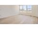 Spacious living room with light wood flooring, neutral walls, and large windows offering abundant natural light at 6562 Arbor Blvd # 1, Thornton, CO 80602
