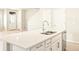 Modern kitchen island featuring quartz countertops and stainless steel sink at 741 N Tibet St, Aurora, CO 80018