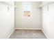 Bright walk-in closet with neutral carpet, white walls, shelving, and a window with a view at 741 N Tibet St, Aurora, CO 80018