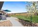 Pleasant backyard with stone path, patio, fire pit, and playset at 208 Dorothy Dr, Berthoud, CO 80513
