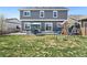 Spacious backyard features a patio, play set, green grass, and a privacy fence at 208 Dorothy Dr, Berthoud, CO 80513