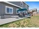 Enjoyable backyard features a patio with outdoor furniture, playset, and green grass at 208 Dorothy Dr, Berthoud, CO 80513