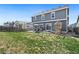 Expansive backyard with green lawn, patio area, playset, and privacy fence, perfect for outdoor activities at 208 Dorothy Dr, Berthoud, CO 80513