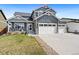 Two-story home with a well-maintained lawn and three car garage at 208 Dorothy Dr, Berthoud, CO 80513