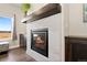 Living room fireplace with tile surround and wood mantle at 208 Dorothy Dr, Berthoud, CO 80513
