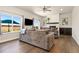 Comfortable living room featuring a fireplace, large windows, and a gray sofa at 208 Dorothy Dr, Berthoud, CO 80513