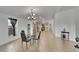 Open-concept dining area featuring a stylish chandelier and light tile flooring at 243 Cherokee Ct, Brighton, CO 80603